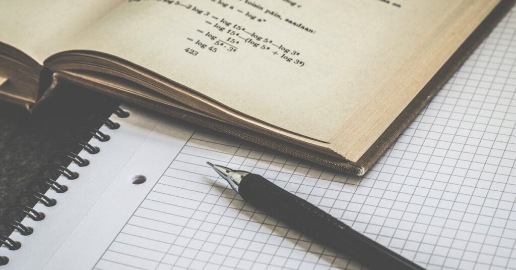 Mathematical study scene with open book, graph paper, and pen for learning and homework.