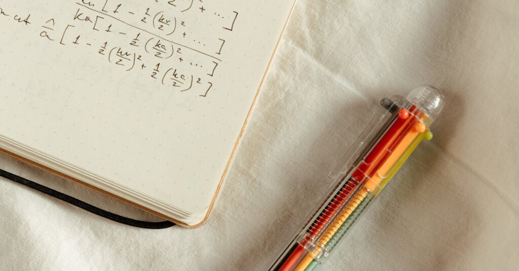 Handwritten math formulas on a notepad with a colorful pen on a white background.