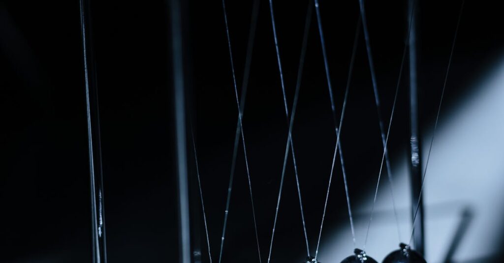 Newton's cradle in a dark setting, illustrating physics concepts with elegant design.