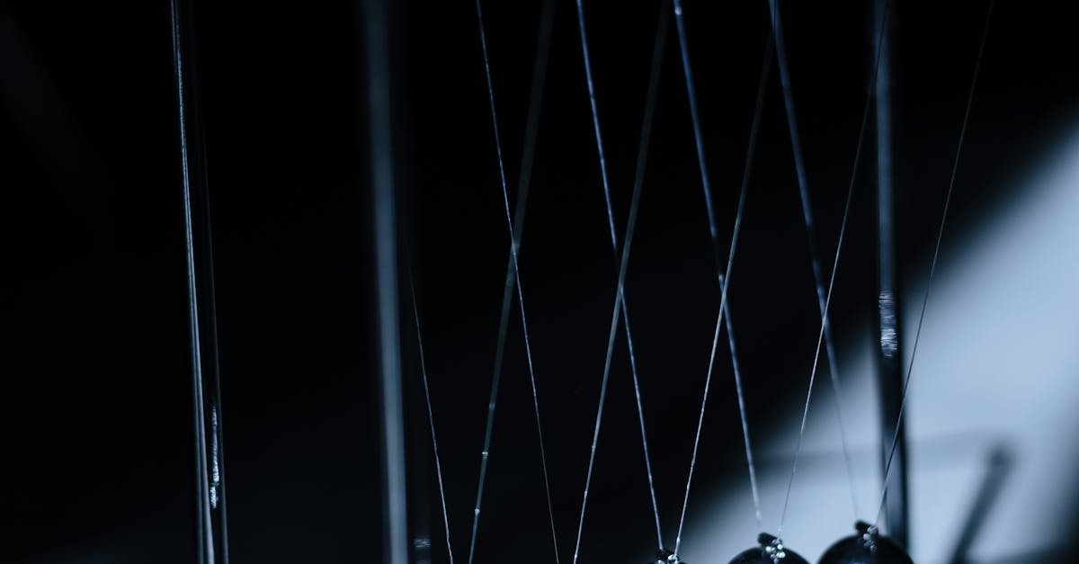 Newton's cradle in a dark setting, illustrating physics concepts with elegant design.