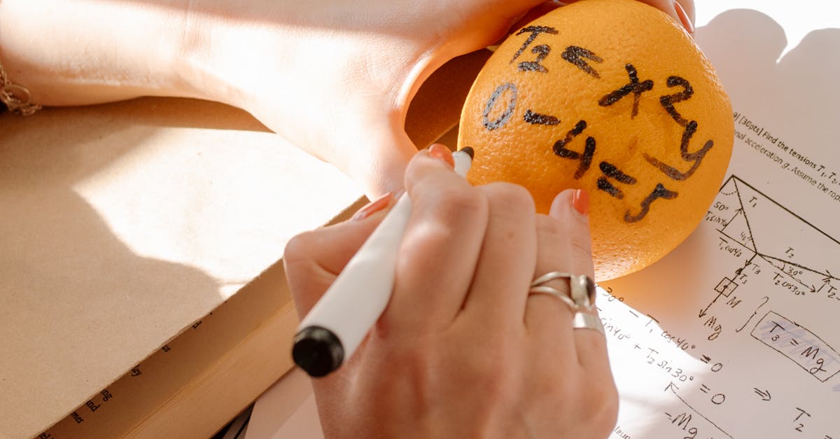 Innovative study session featuring math formulas written on an orange to enhance learning.